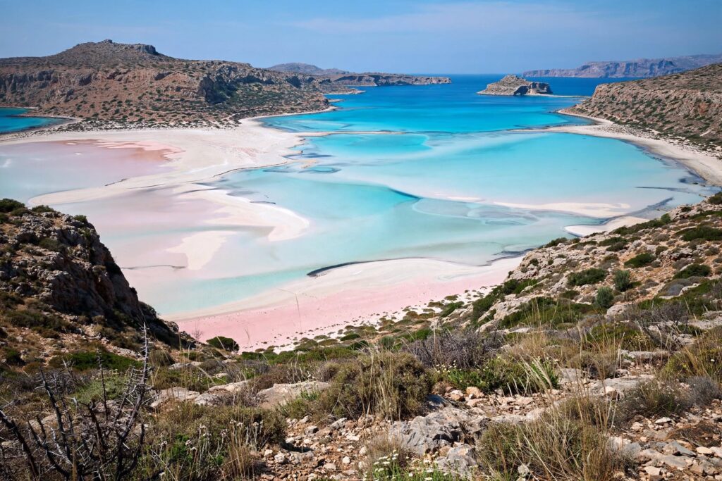 Panoramic view across turquoise waters and pale sand at Balos Lagoon in Crete