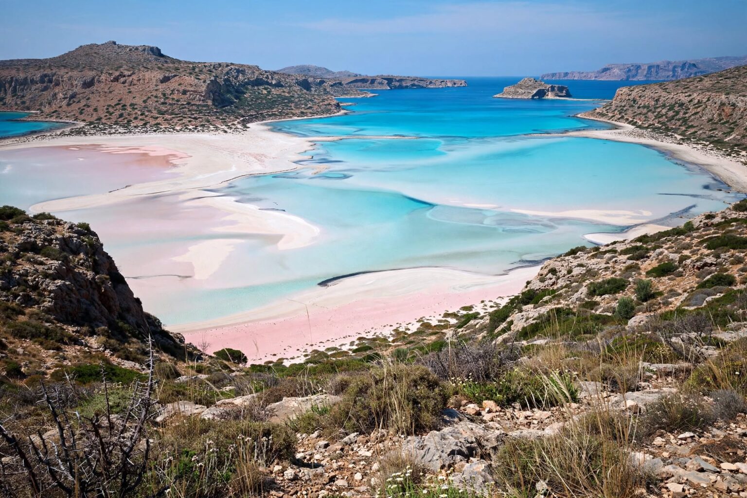 Panoramic view across turquoise waters and pale sand at Balos Lagoon in Crete