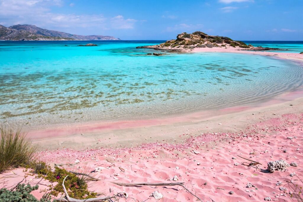 Pink-toned sand and shallow turquoise water at Elafonisi beach in Crete