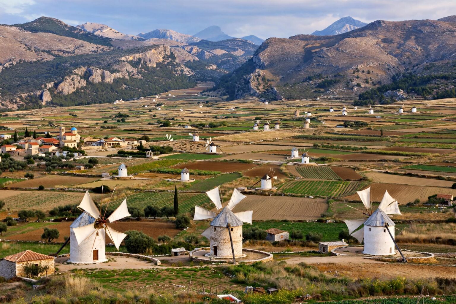 Traditional white windmills across the Lasithi Plateau among Cretan mountains